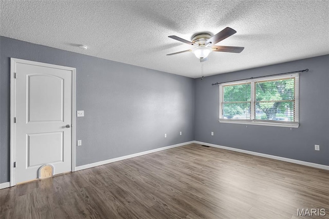 1016 Andra Dr, Maryville, IL 62062 - spare room with a ceiling fan, a textured ceiling, wood finished floors, and a smoke detector