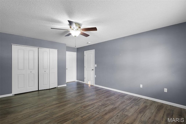 1016 Andra Dr, Maryville, IL 62062 - unfurnished bedroom featuring dark wood-style flooring, a closet, a textured ceiling, and ceiling fan