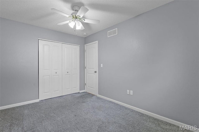1016 Andra Dr, Maryville, IL 62062 - unfurnished bedroom with carpet floors, a closet, a textured ceiling, and a ceiling fan