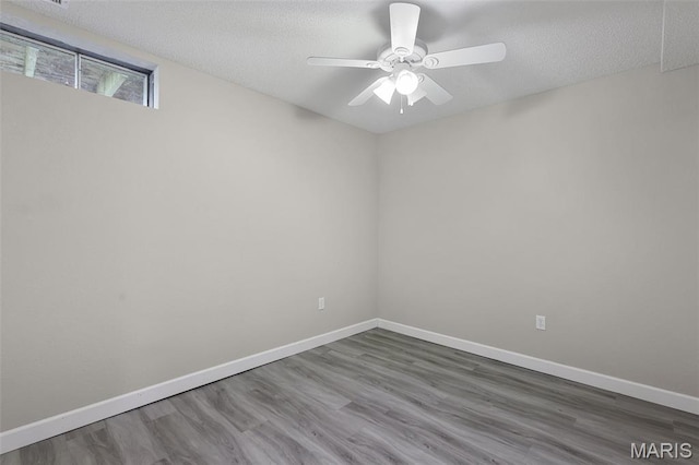 1016 Andra Dr, Maryville, IL 62062 - unfurnished room with a textured ceiling, wood finished floors, and a ceiling fan