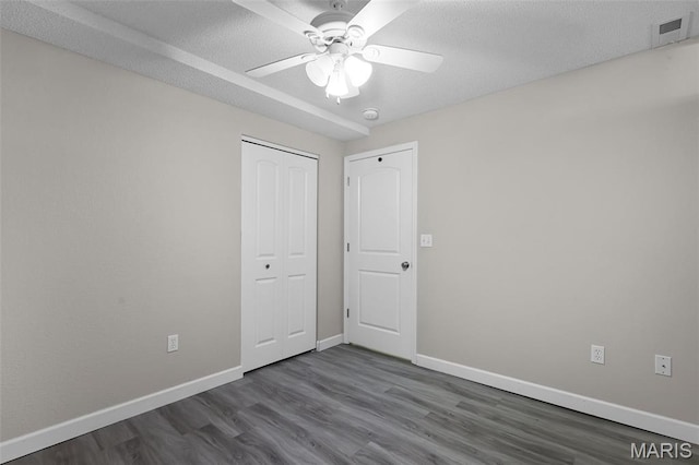 1016 Andra Dr, Maryville, IL 62062 - unfurnished bedroom with dark wood-type flooring, a closet, and ceiling fan