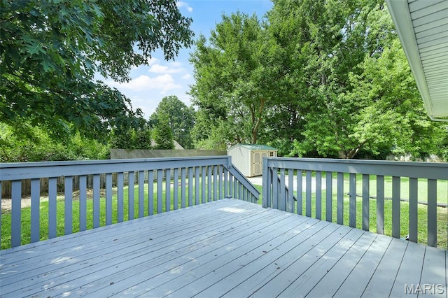 1016 Andra Dr, Maryville, IL 62062 - deck featuring a storage unit, view of wooded area, and a fenced backyard