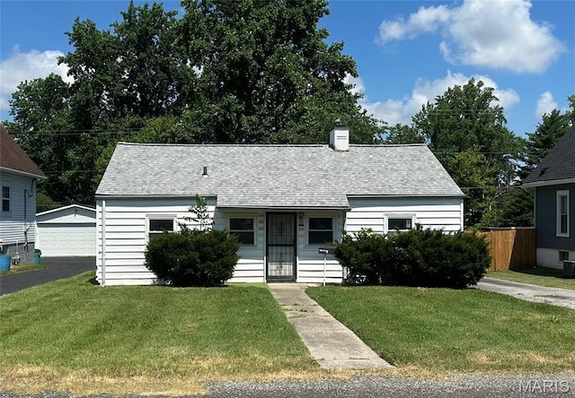 1325 Orchard St, Belleville, IL 62221 - view of front of home with a chimney, an outbuilding, roof with shingles, and a detached garage