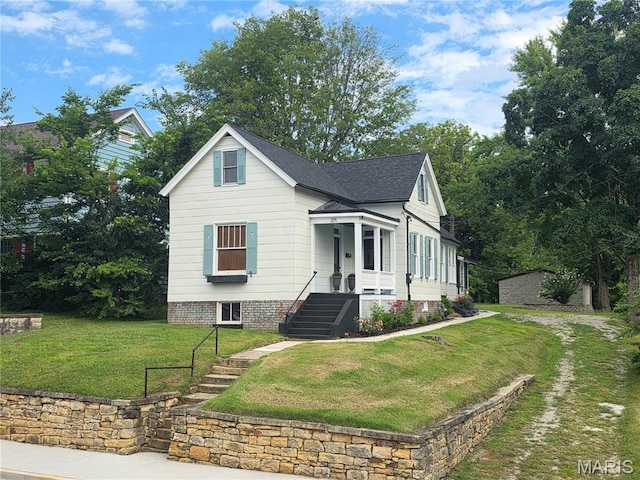 371 Jefferson St, Saint Genevieve, MO 63670 - view of front facade with a front lawn, a shingled roof, and an outbuilding