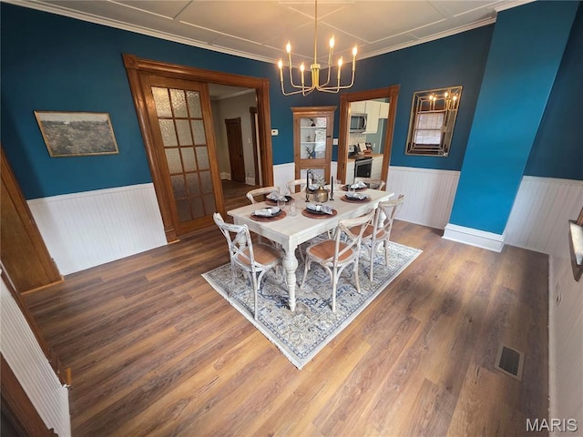 371 Jefferson St, Saint Genevieve, MO 63670 - dining space featuring wainscoting, a chandelier, wood finished floors, and ornamental molding