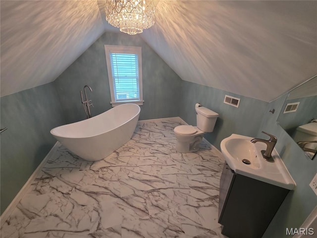 371 Jefferson St, Saint Genevieve, MO 63670 - bathroom with vanity, a freestanding bath, lofted ceiling, marble finish flooring, and a chandelier
