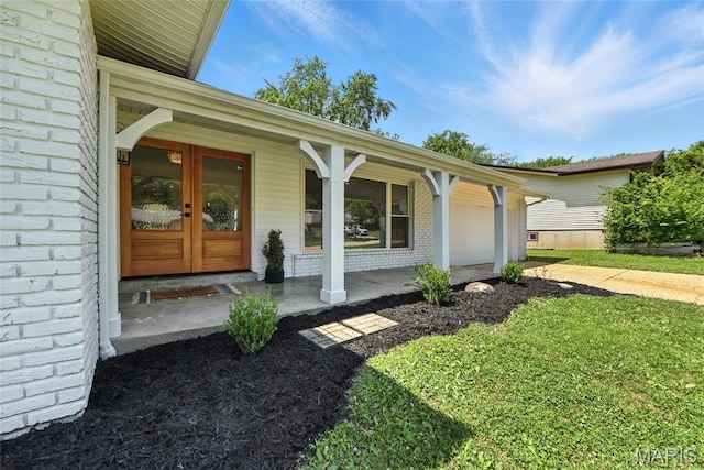 15282 Springrun Dr, Chesterfield, MO 63017 - doorway to property with an attached garage, french doors, brick siding, covered porch, and driveway
