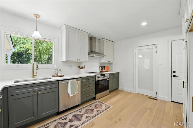 15282 Springrun Dr, Chesterfield, MO 63017 - kitchen with wall chimney range hood, stainless steel appliances, light wood finished floors, light countertops, and recessed lighting