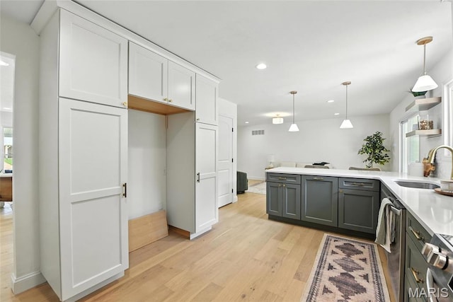 15282 Springrun Dr, Chesterfield, MO 63017 - kitchen featuring light wood-style flooring, light countertops, recessed lighting, hanging light fixtures, and white cabinetry