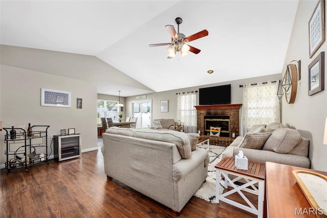 182 Cherrywood Parc Dr, Ofallon, MO 63368 - living room with lofted ceiling, ceiling fan, dark wood-style flooring, and a fireplace