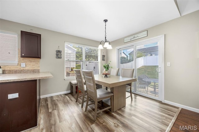 182 Cherrywood Parc Dr, Ofallon, MO 63368 - dining area featuring a chandelier, wood finished floors, and healthy amount of natural light