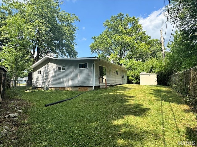 224 Lucinda Dr, Fairview Heights, IL 62208 - rear view of house with a storage unit and entry steps