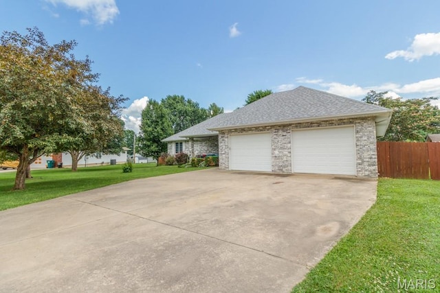 1124 Carpentry Cir, Lebanon, MO 65536 - view of home's exterior with concrete driveway, a garage, and a shingled roof