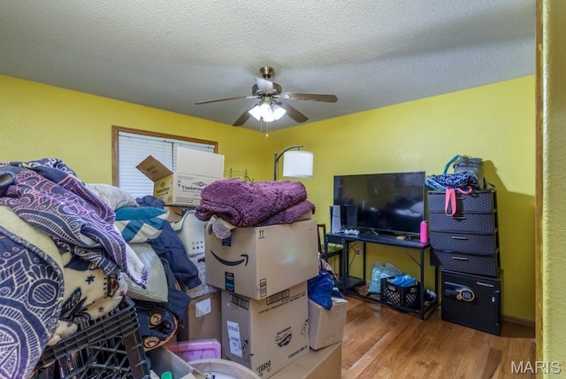 1124 Carpentry Cir, Lebanon, MO 65536 - bedroom with wood finished floors, ceiling fan, and a textured ceiling