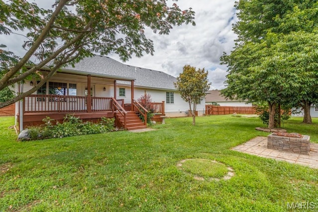 1124 Carpentry Cir, Lebanon, MO 65536 - rear view of house featuring an outdoor fire pit, a wooden deck, and a shingled roof