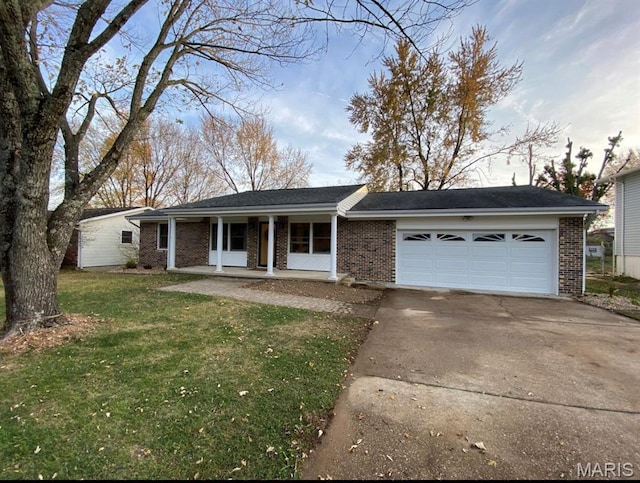 1322 Highland Dr, Rolla, MO 65401 - single story home with a porch, brick siding, concrete driveway, and a front lawn