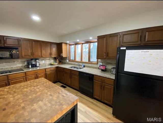 1322 Highland Dr, Rolla, MO 65401 - kitchen with black appliances, light countertops, decorative backsplash, recessed lighting, and light wood-style flooring