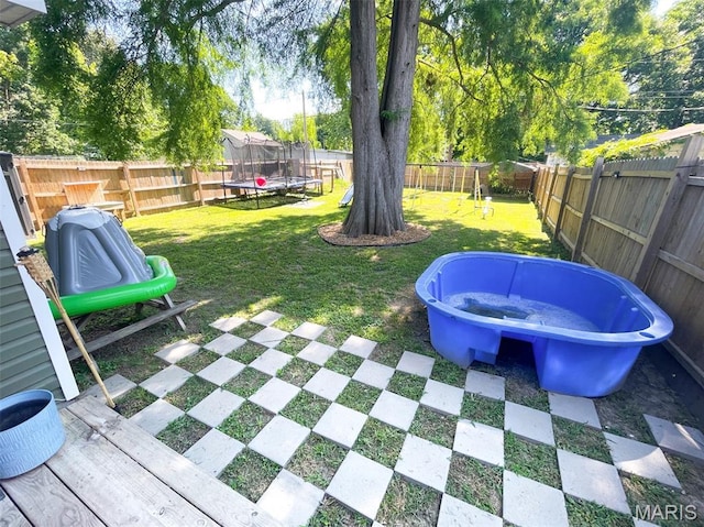 712 W Oak St, Dexter, MO 63841 - fenced backyard with a trampoline and a playground