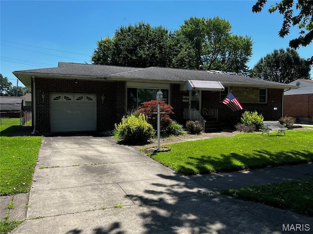 3148 Davis Ave, Granite City, IL 62040 - ranch-style home with an attached garage, a front yard, brick siding, and concrete driveway