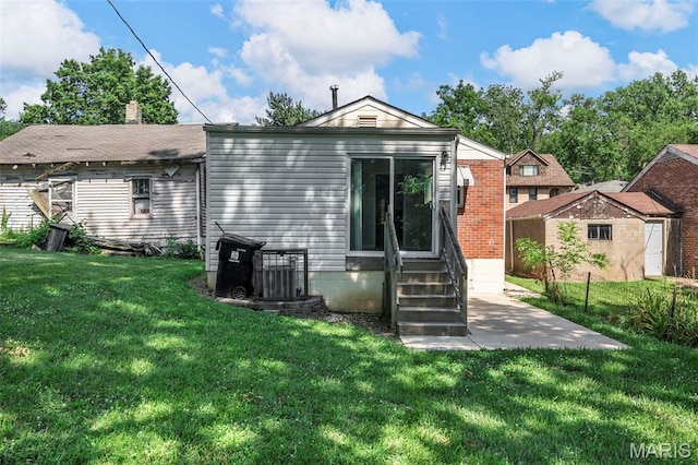 1237 Fairview Ave, University City, MO 63130 - back of property with entry steps, a yard, and a patio area