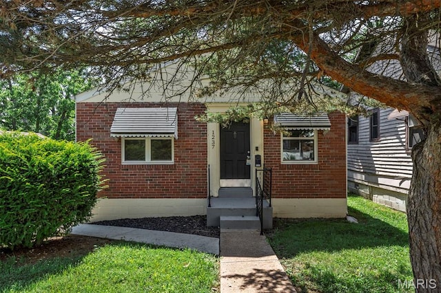 1237 Fairview Ave, University City, MO 63130 - view of front of home with brick siding and a front lawn