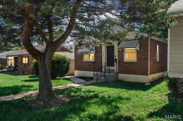 1237 Fairview Ave, University City, MO 63130 - rear view of house featuring brick siding and a lawn