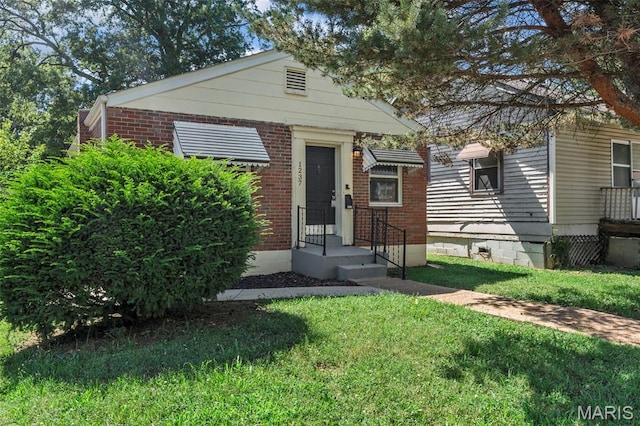 1237 Fairview Ave, University City, MO 63130 - view of front of house featuring brick siding and a front lawn