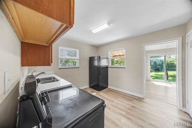 1237 Fairview Ave, University City, MO 63130 - laundry area featuring cabinet space and light wood-style floors