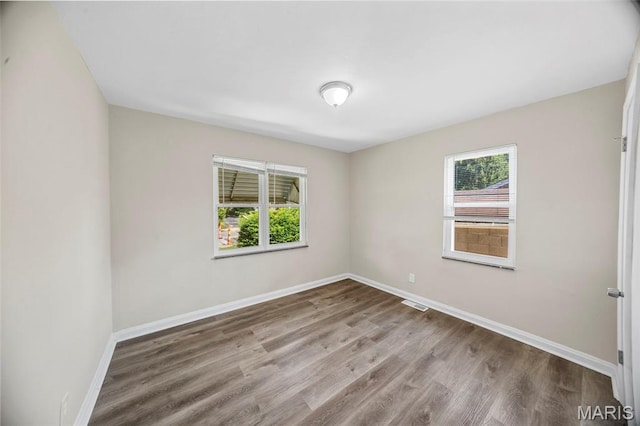 1237 Fairview Ave, University City, MO 63130 - empty room with healthy amount of natural light and wood finished floors