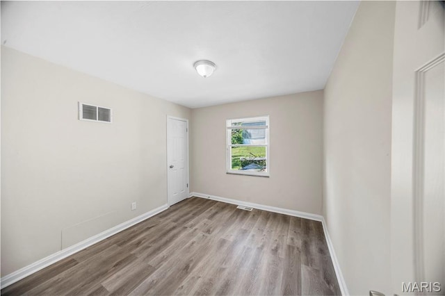 1237 Fairview Ave, University City, MO 63130 - spare room with wood finished floors and baseboards