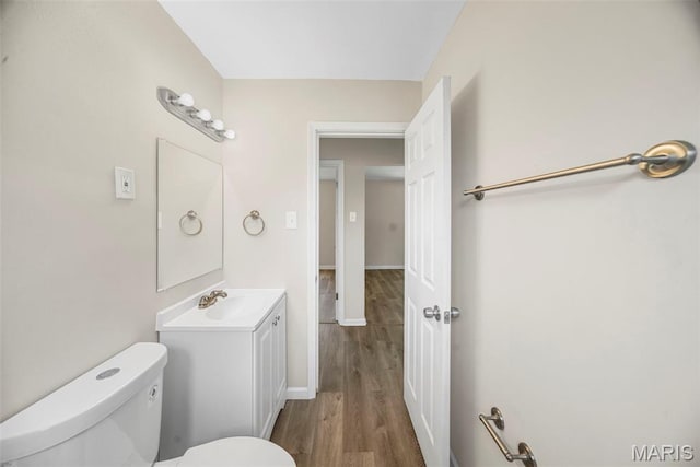 1237 Fairview Ave, University City, MO 63130 - half bathroom featuring vanity and wood finished floors