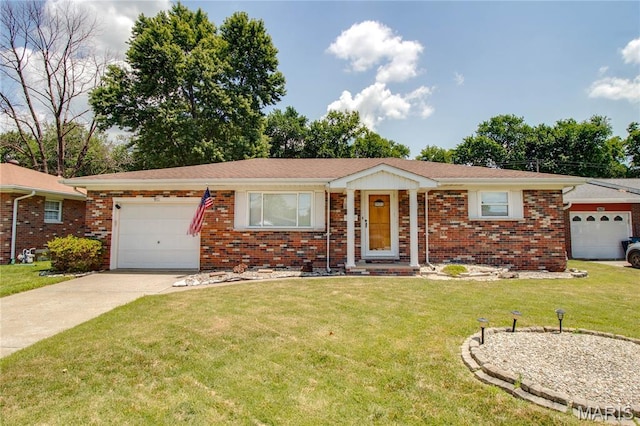 971 Cedar Dr, Wood River, IL 62095 - single story home with a garage, concrete driveway, a front yard, and brick siding