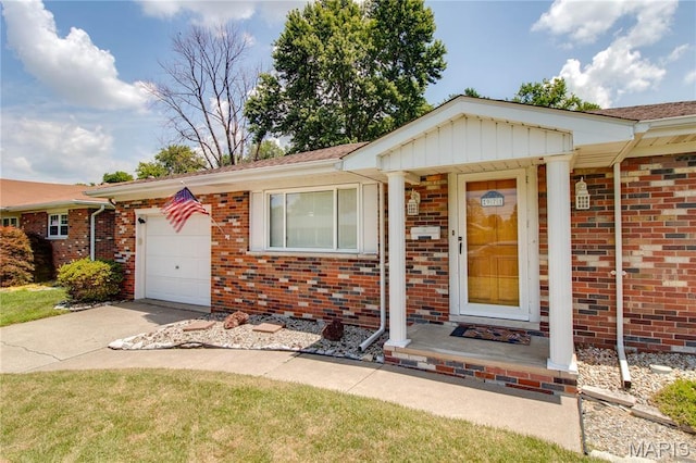 971 Cedar Dr, Wood River, IL 62095 - view of front of property featuring brick siding, concrete driveway, and a garage