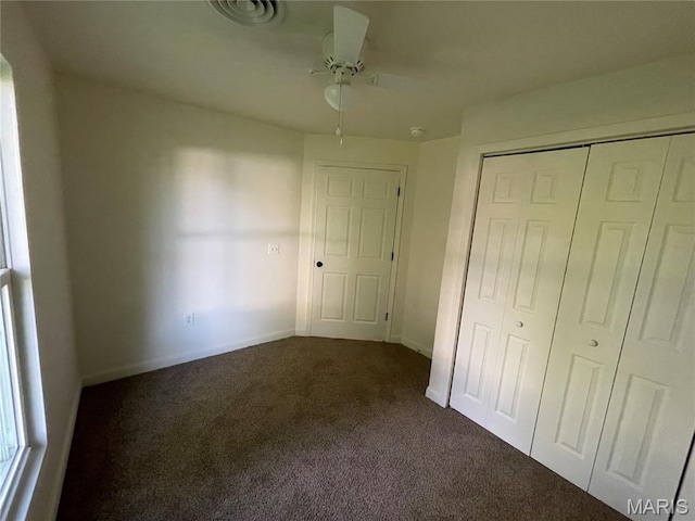 211 N Davis St, Cuba, MO 65453 - unfurnished bedroom featuring dark colored carpet, a closet, and ceiling fan