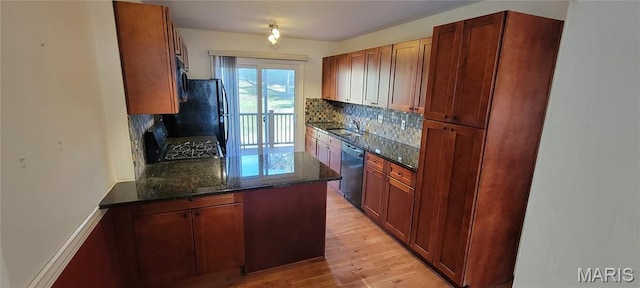 964 Claygate Ct, Ballwin, MO 63021 - kitchen with stove, tasteful backsplash, black dishwasher, stainless steel microwave, and dark stone counters