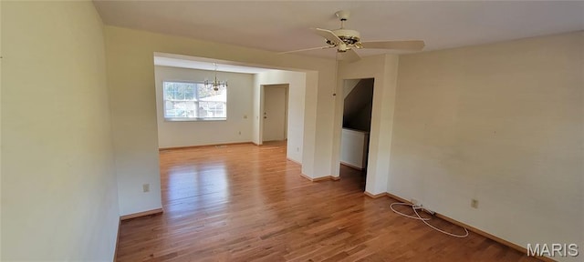 964 Claygate Ct, Ballwin, MO 63021 - unfurnished room with a chandelier, light wood-style floors, and ceiling fan