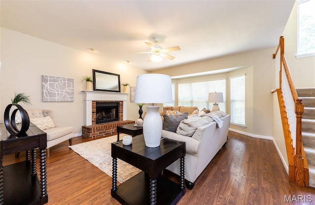 602 Whispering Willows Ct, Ballwin, MO 63021 - living room with stairway, a ceiling fan, dark wood-style floors, and a fireplace