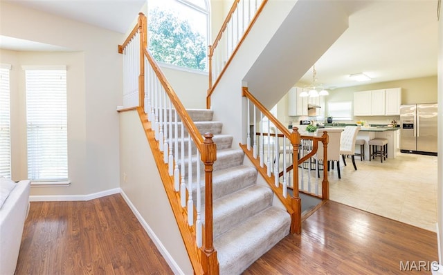 602 Whispering Willows Ct, Ballwin, MO 63021 - stairs featuring wood finished floors and a chandelier