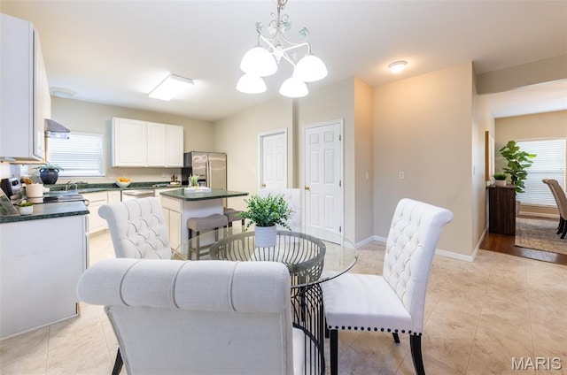 602 Whispering Willows Ct, Ballwin, MO 63021 - dining space with healthy amount of natural light, a chandelier, and light tile patterned flooring