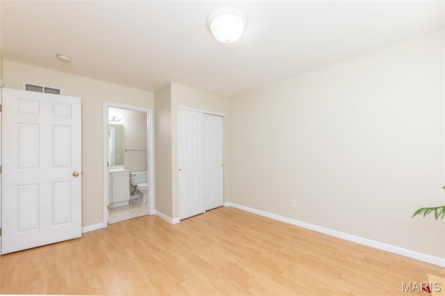 602 Whispering Willows Ct, Ballwin, MO 63021 - unfurnished bedroom with light wood finished floors, ensuite bathroom, and a closet
