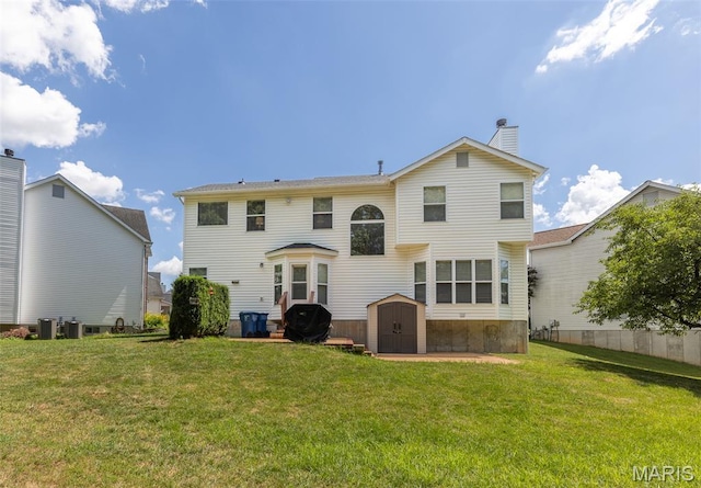 602 Whispering Willows Ct, Ballwin, MO 63021 - back of house with a shed, a yard, and a chimney