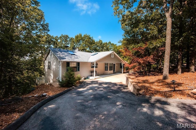 7040 Oak Shadow Ln, High Ridge, MO 63049 - ranch-style house featuring driveway, a chimney, and solar panels