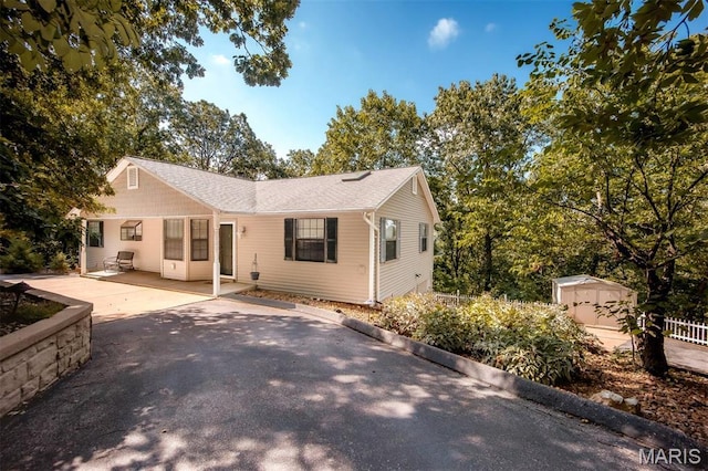 7040 Oak Shadow Ln, High Ridge, MO 63049 - single story home with a storage unit and a patio