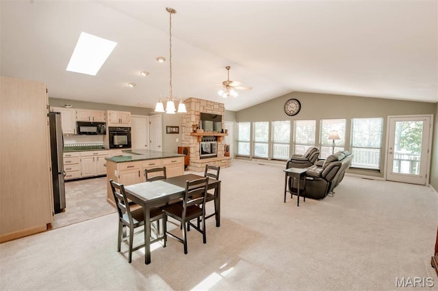 7040 Oak Shadow Ln, High Ridge, MO 63049 - dining space featuring lofted ceiling, a skylight, healthy amount of natural light, and light carpet