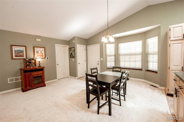 7040 Oak Shadow Ln, High Ridge, MO 63049 - dining room with lofted ceiling, a chandelier, and light carpet