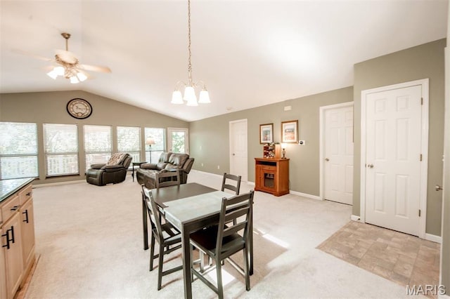 7040 Oak Shadow Ln, High Ridge, MO 63049 - dining space with light colored carpet, a ceiling fan, vaulted ceiling, and a chandelier