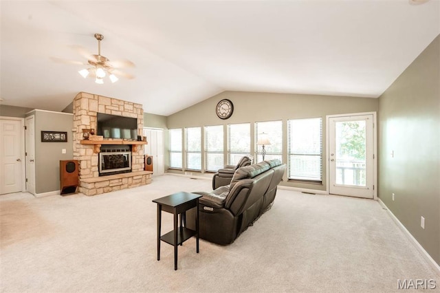 7040 Oak Shadow Ln, High Ridge, MO 63049 - living area featuring lofted ceiling, carpet floors, ceiling fan, and a stone fireplace