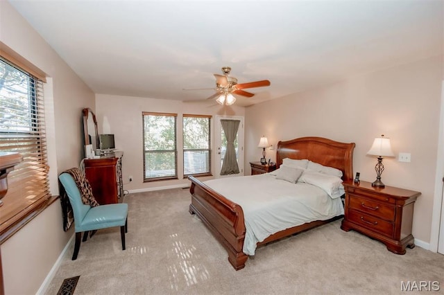7040 Oak Shadow Ln, High Ridge, MO 63049 - bedroom featuring multiple windows, light carpet, and ceiling fan