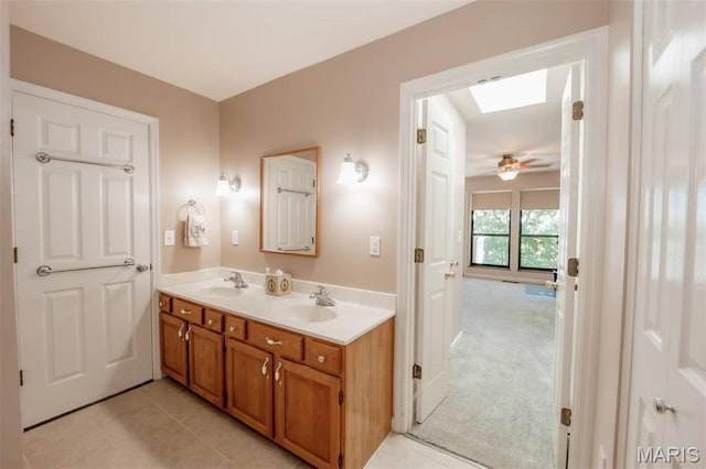 7040 Oak Shadow Ln, High Ridge, MO 63049 - full bath featuring double vanity, a skylight, and tile patterned floors
