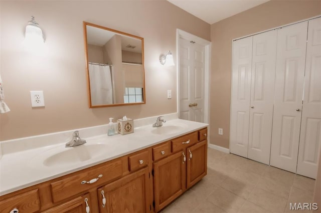 7040 Oak Shadow Ln, High Ridge, MO 63049 - bathroom featuring a closet, double vanity, and tile patterned flooring